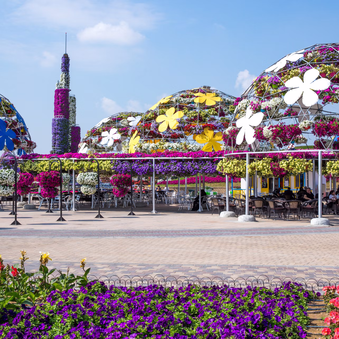 Walk under the canopy of vibrant umbrellas and relax at the garden’s many shaded cool areas.