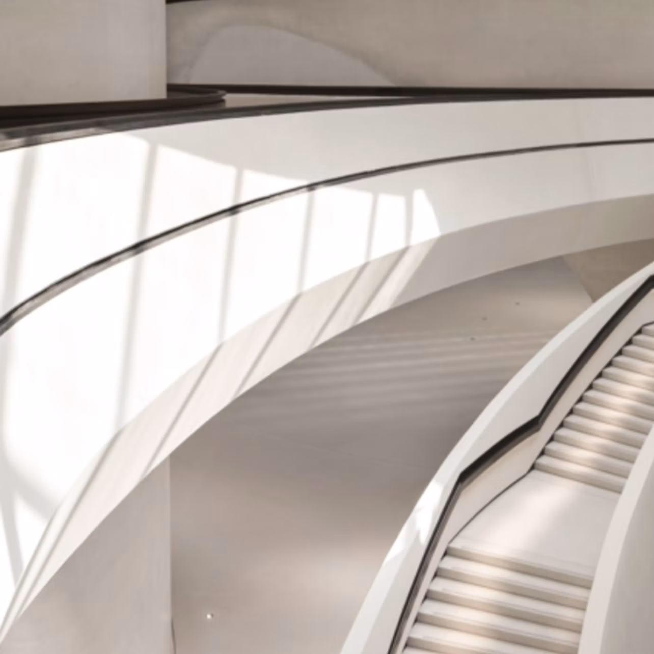 Curved white architectural design with stairs and railings, illuminated by natural light casting shadows.